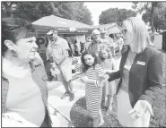  ?? NWA Democrat-Gazette/FLIP PUTTHOFF ?? Celeste Williams (right), Democratic congressio­nal candidate, talks Saturday with voters at the annual Little Flock Picnic.