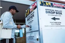  ?? AP PHOTO/JOSE LUIS MAGANA ?? A voter drops his ballot in a drop box at Marilyn J. Praisner Community Recreation Center during Election Day 2022 in Burtonsvil­le, Md.