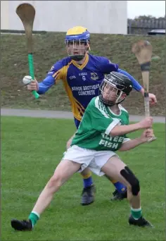  ??  ?? A determined James Cousins gets his shot away from the right corner as Michael Mulligan (Clúain O’Rahilly’s) tries to close him down.