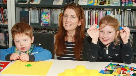  ??  ?? Leán Byrne with her children Cathal and Kate at the Lego storytelli­ng event in Gorey Library.