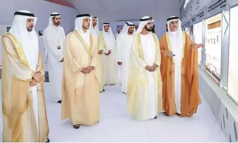  ?? WAM ?? Shaikh Mohammad being briefed about the solar park by Saeed Mohammad Al Tayer during a tour of the facility at Al Qudra yesterday. Shaikh Hamdan, Shaikh Mansour, other shaikhs and senior officials are present.