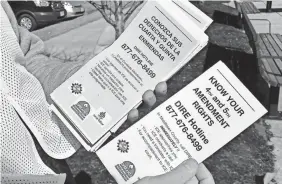  ??  ?? A volunteer with the Deportatio­n and Immigratio­n Response Equipo has pamphlets explaining immigrants’ rights.