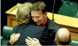  ?? PHOTO: ANDREW GORRIE/STUFF ?? Green MP the late Rod Donald hugs Labour MP Tim Barnett, right, after the third reading of the Civil Union Bill.