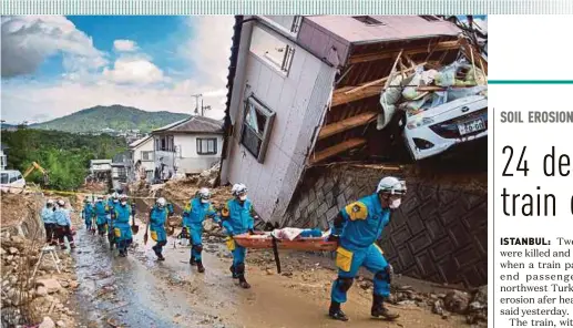  ?? AFP PIC ?? Rescuers at work in Kumano, Hiroshima prefecture, yesterday.