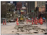  ?? (AP/Charlie Riedel) ?? Work goes on Wednesday for a project to replace old waterlines under Main Street in Kansas City, Mo. President Joe Biden’s infrastruc­ture proposal includes $111 billion to replace the nation’s lead water pipes and upgrade sewers.