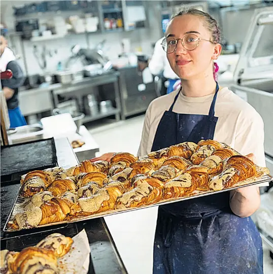  ?? ?? Manon Martin, a 22-year-old baker, with a fresh batch of crookies at Maison Louvard in Paris. Tiktok users have been queuing up to get a taste of the croissant-cookie crossover after it went viral