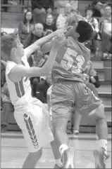  ?? Tim Conover ?? Austin Harvey of Broken Bow, pictured above, ends up fouling the NPSP ball handler as he defends him from driving the ball to the hoop.