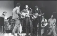  ?? THE ASSOCIATED PRESS ?? In this file photo, Bob Dylan, center, performs with drummer Levon Helm, left, Rick Danko, second left, and Robbie Robertson of The Band at Carnegie Hall in New York, in Dylan’s first public appearance after his 1966 motorcycle accident.