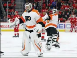  ?? PAUL SANCYA — THE ASSOCIATED PRESS ?? Flyers goaltender Alex Lyon, left, replaces Petr Mrazek during the second period of the team’s eventual shootout loss in Detroit.