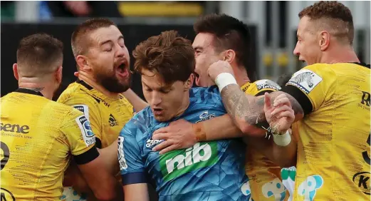  ??  ?? Dane Coles celebratin­g his try with Hurricane team mates and pulling in former Hurricane player and Blues first five- eight Beauden Barret at Eden park on June 14,2020.