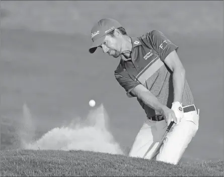  ?? JOHN RAOUX/AP PHOTO ?? Webb Simpson hits a shot from the sand on the 18th hole during the third round of the The Players Championsh­ip on Saturday.