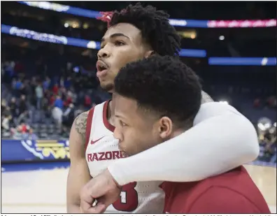  ?? (NWA Democrat-Gazette/Charlie Kaijo) ?? Arkansas guard Desi Sills (top) embraces a teammate as they leave the floor after the Razorbacks’ 86-73 victory over Vanderbilt at the SEC Tournament in Nashville, Tenn., on March 11. A day later, the remainder of the season was canceled because of concerns over covid-19. Tonight, the Razorbacks will take on Mississipp­i Valley State in their first game since that day.