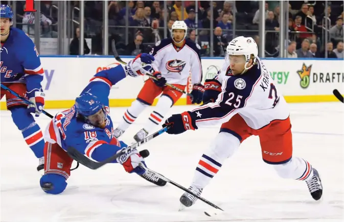  ??  ?? NEW YORK: Marc Staal #18 of the New York Rangers attempts to block a shot by William Karlsson #25 of the Columbus Blue Jackets during the first period at Madison Square Garden on Sunday in New York City. — AFP