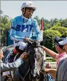  ??  ?? Skip Dickstein / Special to Times Union Jockey Ricardo Santana Jr. is congratula­ted by trainer Rob Atras after winning the Coaching Club American Oaks on Saturday.