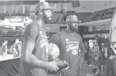  ?? AGENCE FRANCE PRESSE ?? ORLANDO, FL — Anthony Davis #3 and LeBron James #23 of the Los Angeles Lakers holds the Western Conference Finals trophy after winning Game Five of the Western Conference Finals against the Denver Nuggets in Orlando, Florida at AdventHeal­th Arena.