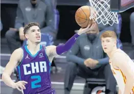  ?? JARED C. TILTON/ GETTY ?? Hornets rookie PG LaMelo Ball, at 19 years old, on Saturday night became the youngest player in league history to record a triple- double in a victory over the Hawks.