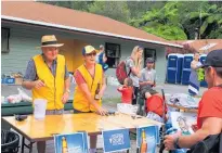  ??  ?? Katikati Lions team leader Don Mossop and Rhonnie Hughes serving competitor­s at Aongatete Lodge at the Goat Goes Bush Kaimai event.