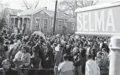  ?? Roberto Schmidt / AFP via Getty Images file ?? A large crowd marches down the streets of Selma, Ala., several years ago while re-creating the peaceful 1965 voting rights march that ended in violence.