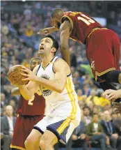  ?? JANE TYSKA/STAFF ?? The Warriors’ Zaza Pachulia goes to shoot after faking the Cavaliers’ Tristan Thompson in the third quarter.