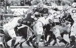  ?? MATT ROURKE AP ?? Navy quarterbac­k Tai Lavatai runs for the first of his two touchdowns during the first quarter of Navy’s 17-13 victory over Army on Saturday in East Rutherford, New Jersey.