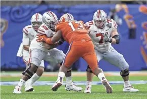  ?? KYLE ROBERTSON/COLUMBUS DISPATCH ?? Ohio State right guard Wyatt Davis (52) almost certainly will leave for the NFL after the national championsh­ip game. Center Josh Myers (71) has not committed but is scheduled to play in the Senior Bowl.