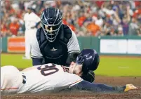  ?? AP ?? CAUGHT IN THE ACT: Jose Trevino applies the tag on Kyle Tucker on Thursday night after the Astro tried stealing home on a distracted Luis Severino.