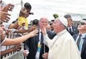  ?? VIA THE ASSOCIATED PRESS] [ALBERTO PIZZOLI/POOL ?? A bruised Pope Francis is shown a baby to bless during his arrival Sunday in Cartagena, Colombia.