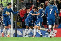  ??  ?? Willian of Chelsea is mobbed by his Chelsea team mates after scoring the equaliser against Liverpool.