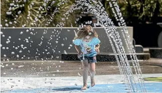  ?? IAIN MCGREGOR ?? Summer’s appeal is perfectly illustrate­d by Lily Tarawa, 5, at Christchur­ch’s Margaret Mahy Playground.