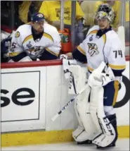  ?? GENE J. PUSKAR — THE ASSOCIATED PRESS ?? Nashville Predators goalie Pekka Rinne, left, sits on the bench after being replaced by Juuse Saros, right, during the third period in Game 2 of the team’s NHL hockey Stanley Cup Final against the Pittsburgh Penguins on Wednesday in Pittsburgh. The...