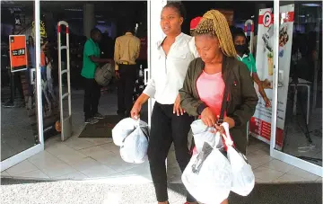  ?? ?? Even in Zimbabwe, shoppers in Harare took advantage of Black Friday yesterday to stock up up on bargain merchandis­e