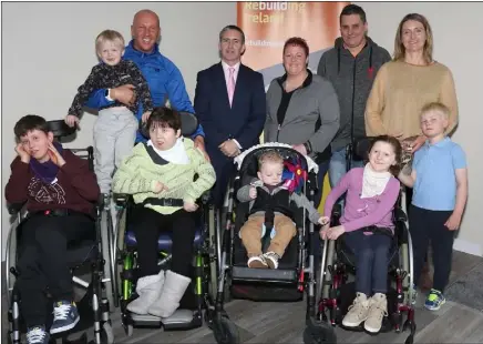  ??  ?? Damien English TD, Minister for Housing and Urban Renewal pictured with the Dempsey-Dobbs-Boyle family, Rita, Will, Lily, Shona Tom, Luke and Patrick and the Sheil family, T.J., Darren and Julie when he visited the special needs homes at Cum an Tobair,...
