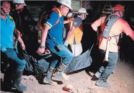  ?? BULLIT MARQUEZ THE ASSOCIATED PRESS ?? The body of a landslide victim is carried in Naga city, Cebu province central Philippine­s.