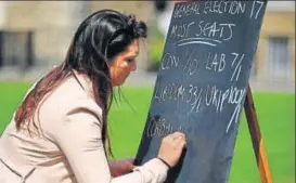  ?? AFP ?? The Big Gamble: A betting firm staff writes odds outside Parliament after May’s announceme­nt.