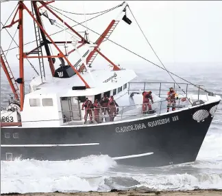  ??  ?? NO, NO! SAVE US! Fishermen await rescue aboard the stalled Carolina Queen III, a scallop trawler that ran aground on Rockaway Beach Thursday morning shortly after a Coast Guard boat capsized while trying to reach them.