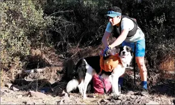  ?? — AFP photo ?? Chiang and his pet Sam, picking up plastic bottles during a plog run at Cerro San Cristobal in Santiago.