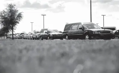  ?? Associated Press ?? Hearses line up outside the Floresvill­e Event Center as a funeral for members of the Holcombe family who were killed in the Sutherland Springs Baptist Church shooting takes place, Wednesday, in Floresvill­e, Texas. A man opened fire inside the church in...