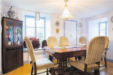  ??  ?? In the dining room, the heavy and bulky 1900s Victorian style walnut table and chairs occupy most of the space. It was made by a Quebec craftsman.