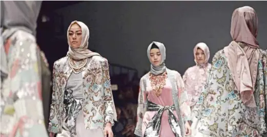  ??  ?? Models present creations by Indonesian Muslim designer Anniesa Hasibuan during Jakarta Fashion Week yesterday.