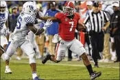  ?? JOSHUA L. JONES / AP ?? Georgia running back D’Andre Swift keeps Kentucky safety Darius West at arm’s length during the second half of the Bulldogs’ comfortabl­e victory.