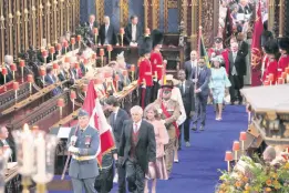  ?? AP ?? Representa­tives from the King’s Realms, bearing the national flags, accompanie­d by governors general and prime ministers arrive at Westminste­r Abbey for the coronation ceremony of Britain’s King Charles III, in London, Saturday, May 6, 2023.