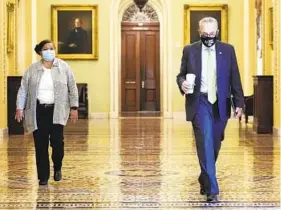  ?? JOSHUA ROBERTS/GETTY ?? Senate Majority Leader Chuck Schumer arrives at his office before opening the Senate for debate on the infrastruc­ture bill on Saturday in Washington.