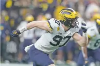  ?? DARRON CUMMINGS/ASSOCIATED PRESS FILE PHOTO ?? Michigan defensive end Aidan Hutchinson rushes up-field during the second half of the Big Ten championsh­ip against Iowa on Saturday in Indianapol­is.