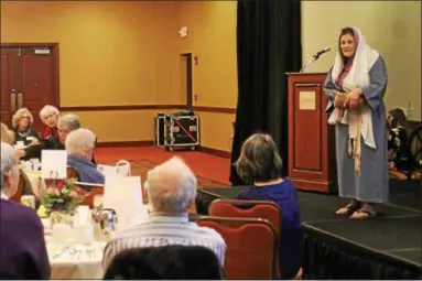  ?? LAUREN HALLIGAN — LHALLIGAN@DIGITALFIR­STMEDIA.COM ?? Martha, played by Maria Heller, addresses the crowd at the sixth annual Famous Ladies’ Tea on Sunday in Troy.