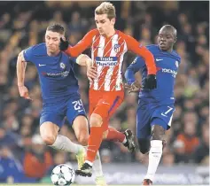  ??  ?? Atletico Madrid’s French striker Antoine Griezmann (centre) vies with Chelsea’s English defender Gary Cahill (left) and Chelsea’s French midfielder N’Golo Kante during a UEFA Champions League Group C football match between Chelsea and Atletico Madrid...