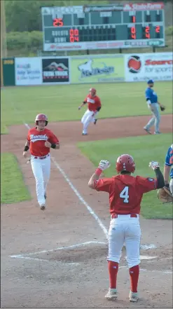  ?? NEWS PHOTO SEAN ROONEY ?? Blake Rowlett (left) scores the sixth run of the second inning for the Medicine Hat Mavericks, as Caleb Longley turns for home and Louie Canjura (4) awaits him in a Western Major Baseball League game against the Brooks Bombers Tuesday at Athletic Park.