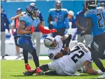  ?? AP PHOTO/MARK ZALESKI ?? Tennessee Titans safety Kevin Byard, left, intercepts a pass during the second half of Sunday’s 24-22 home win against the Las Vegas Raiders. Byard’s play helped overcome a subpar showing for Tennessee’s offense after halftime.