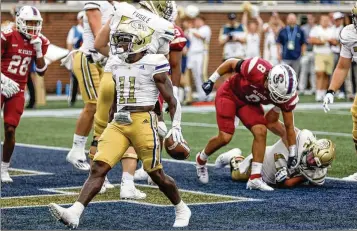  ?? BOB ANDRES FOR THE AJC ?? Georgia Tech running back Jamal Haynes (11) scores a touchdown during Saturday’s game against South Carolina State at Bobby Dodd Stadium. Haynes finished with 113 yards on the ground, including a 67-yard jaunt.