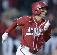  ?? (NWA Democrat-Gazette/Andy Shupe) ?? Arkansas second baseman Robert Moore heads to first after hitting a go-ahead RBI single during the seventh inning Friday against Auburn at Baum-Walker Stadium in Fayettevil­le. Arkansas scored five runs in the seventh to erase a 4-0 deficit en route to a 6-5 victory. More photos at arkansason­line.com/43auua/