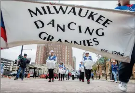  ?? (AP/Kenny Yoo) ?? A banner for the Milwaukee Dancing Grannies flutters in the wind as the Grannies march in the Veterans’ Day parade in Milwaukee.